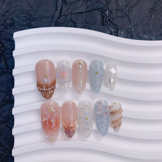 Ceramic tray flat lay of Mermaid's Bloom nails showing 3D butterflies and shells