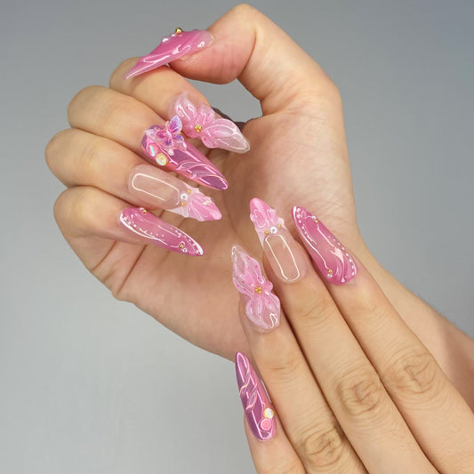 On-hand try-on of Butterfly Kisses almond nails showing pink iridescent shimmer