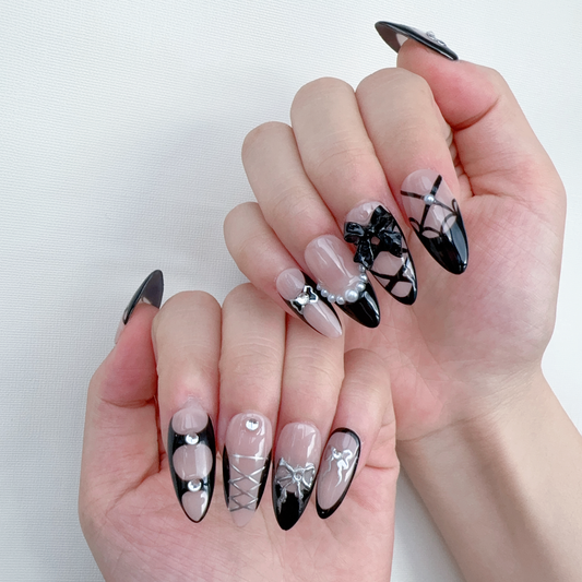 Dark coquette black French tip ribbon bow nails on hand | Gothic balletcore nail inspo