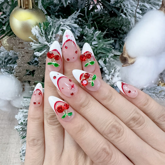 On-hand try-on of Velvet Cherry nails showing 3D sculpted cherries and white tips