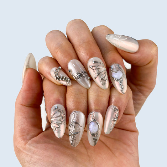 Ethereal silver metallic butterfly press-on nails on hand | Fairycore bridal nail inspo