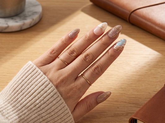 Short almond press-on nails in Aurora Veil worn on a natural hand, showing comfortable fingertip pad clearance for typing and daily wear