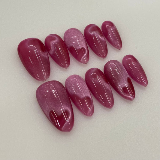 Berry Silk handmade press-on nails flat lay close-up showing handcrafted art detailing on almond nails
