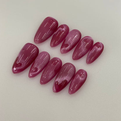Full 10-piece set display of Berry Silk wine cat-eye press-on nails with heart glow