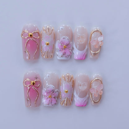 Full 10-piece flat lay display of Ribbon Dream floral and bow press-on nails