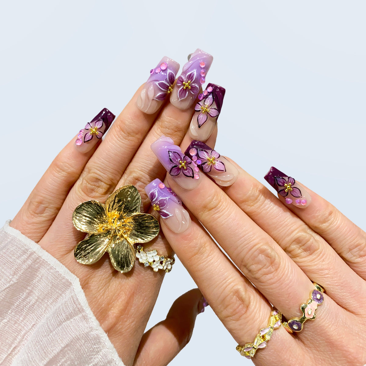 Midnight Blooms 3D floral press-on nails styled with a gold statement flower ring