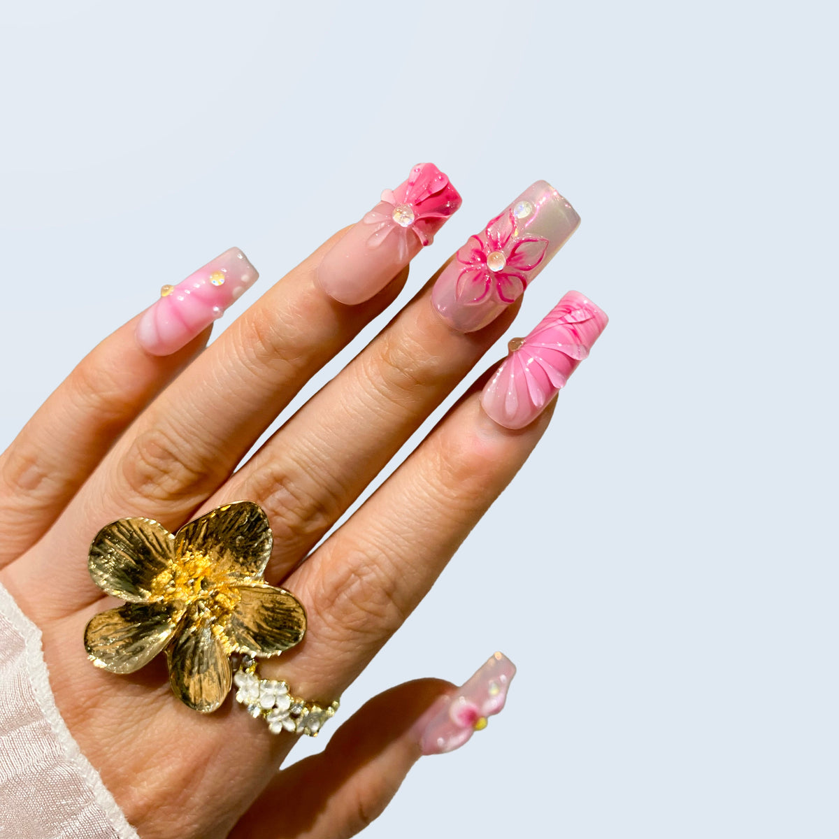 Single hand view of Blush Bloom Spark nails displaying raised shell ridges