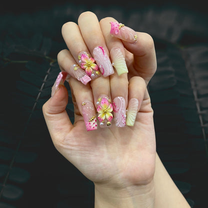 Pastel Petal Charm medium square press-on nails shown on hand in indoor lighting