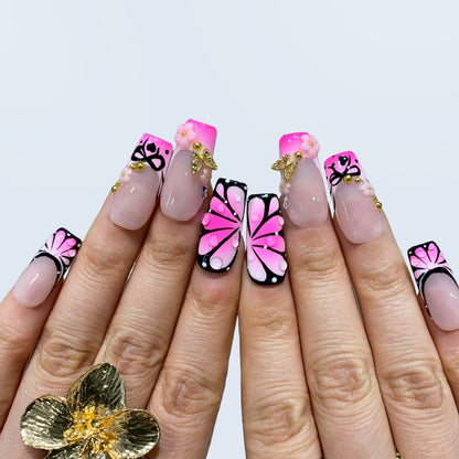 Both hands wearing Sugar Noir Butterfly nails forming full butterfly wings together