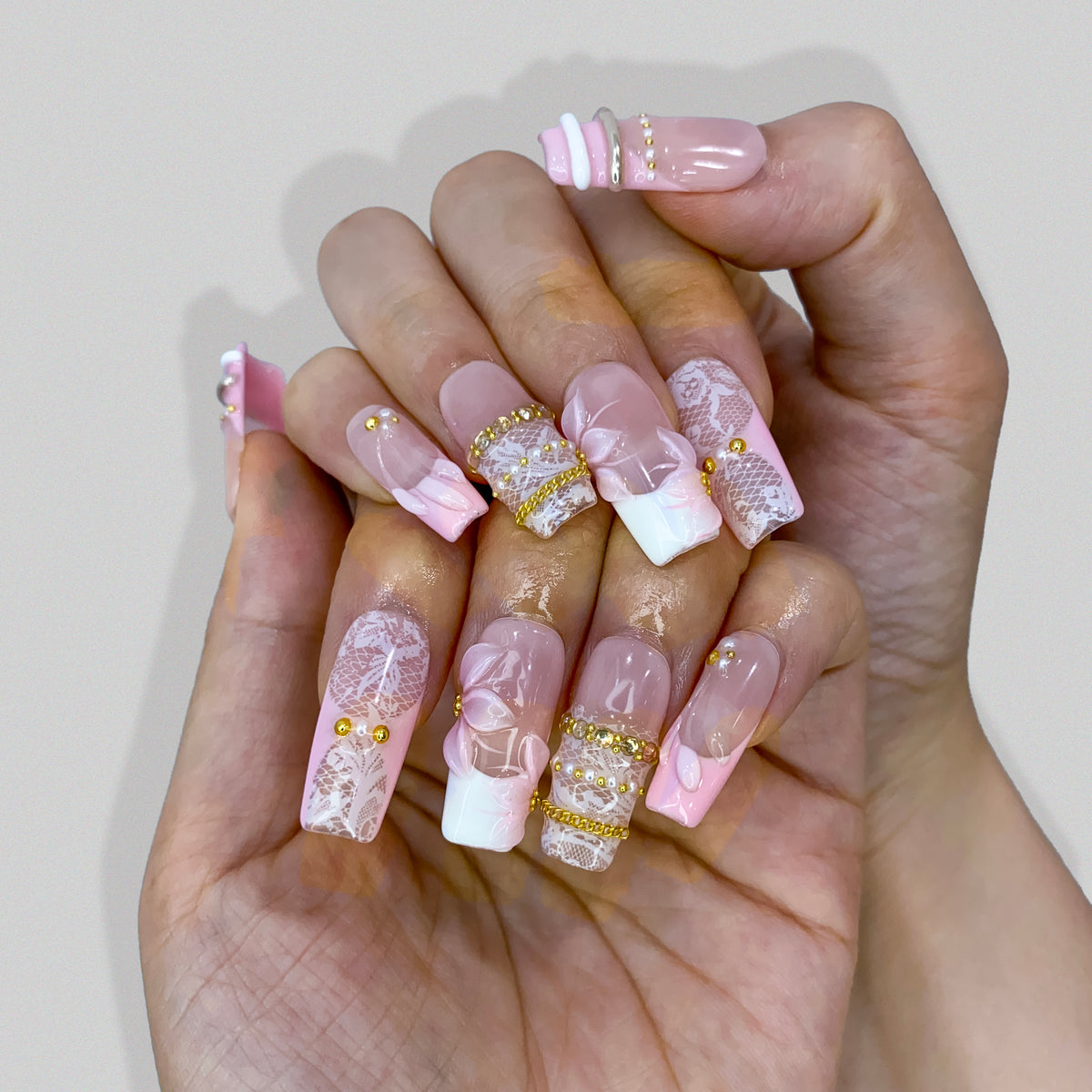 Full set wear display of Blush Lace bridal square press-on nails in natural lighting
