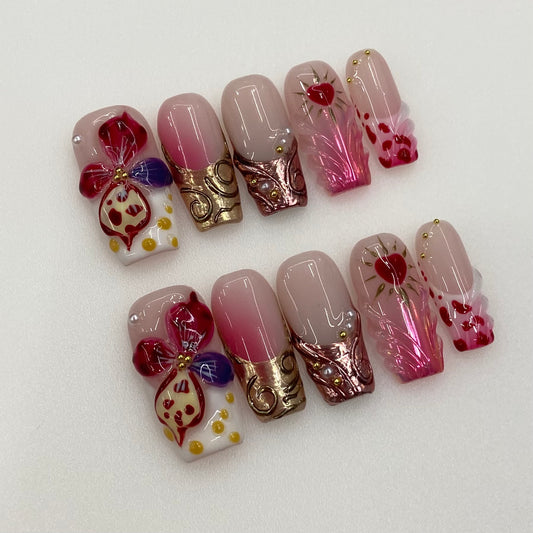 Flat lay photo of Crimson Muse nails showing 3D sacred heart and gold filigree tips