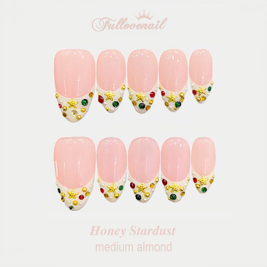 Honey Stardust handmade press-on nails — medium almond set in gold and celestial charms | Fullovenail