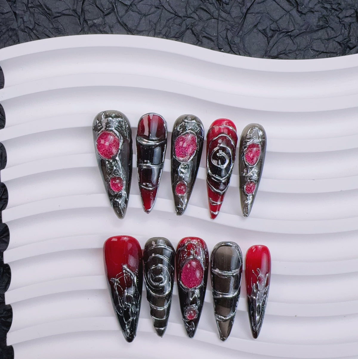Ceramic tray flat lay of Nocturnal Labyrinth nails showing liquid silver wire art