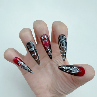 Single hand wearing Nocturnal Labyrinth gothic red aura stiletto press-on nails