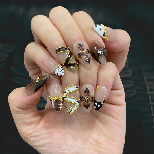 Wild animal print and metallic chrome press-on nails on hand | Safari aesthetic nail inspo
