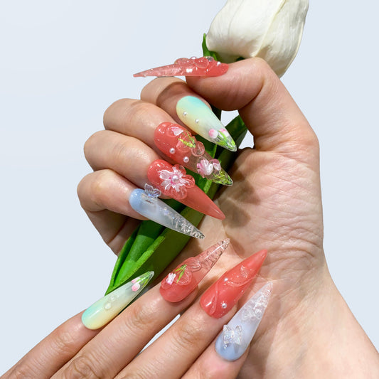 On-hand try-on of Blush Bloom nails showing 3D sculpted tulips and mint ombre