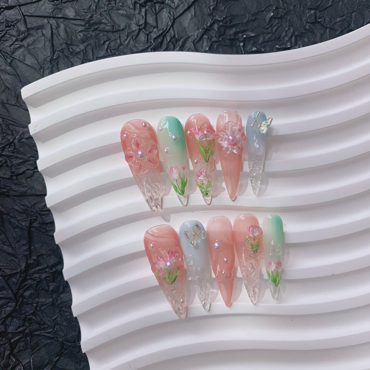 Angled flat lay view of Blush Bloom watercolor pastel floral press-on nails