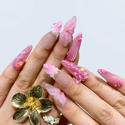 Wear display of Butterfly Kisses almond nails paired with gold ring and pearls