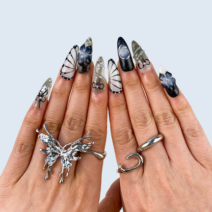 Noir Elegance stiletto press-on nails showing contrast between deep navy and silver