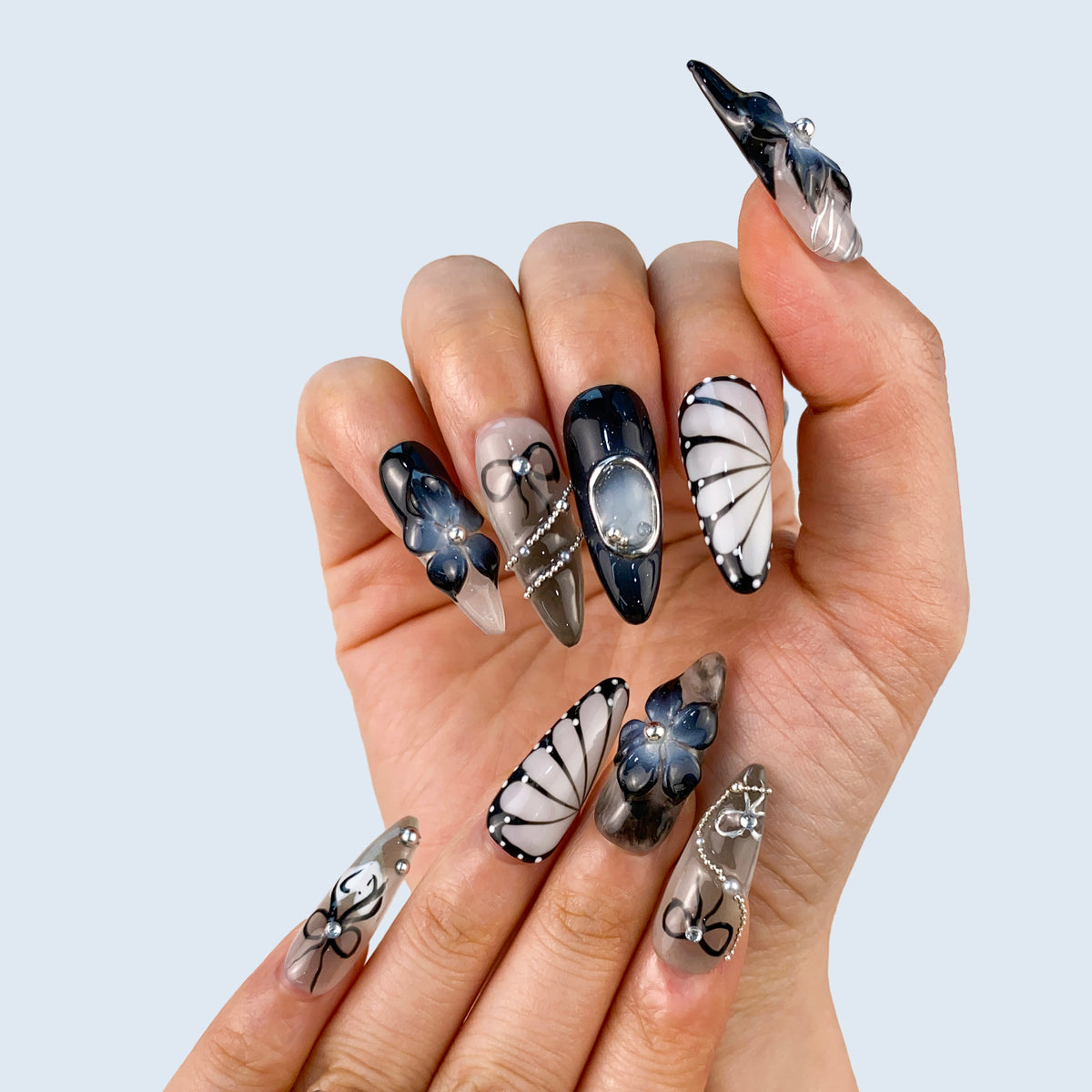 On-hand wear display of Noir Elegance stiletto nails showing intricate gothic motifs