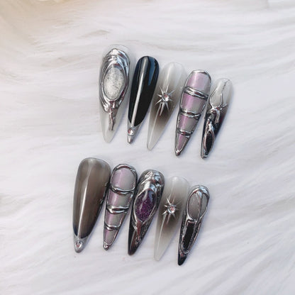 Phantom Aurora nail art on flat surface close-up showing celestial charms and aurora shimmer on stiletto nails