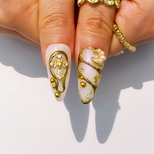 Celestial gold press-on nails on hand | Celestial nail inspo