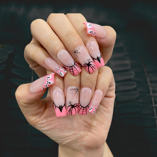 On-hand try-on of Spooky Chic nails showing floating ghosts and black spiderweb art