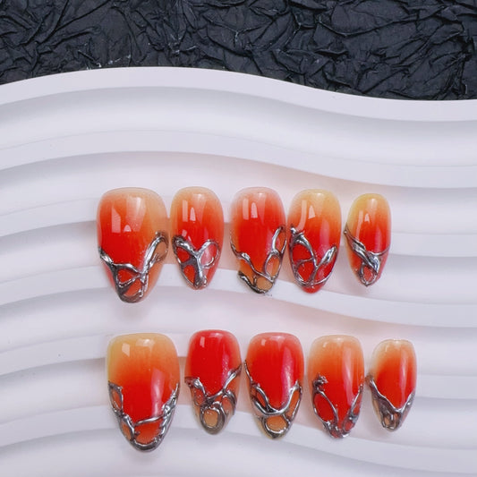 Sunset Chrome almond press-on nails with 3D molten silver frames and red aura ombre