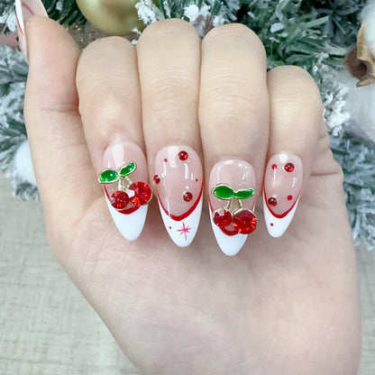 Single hand wearing Velvet Cherry almond press-on nails with red crystal drops