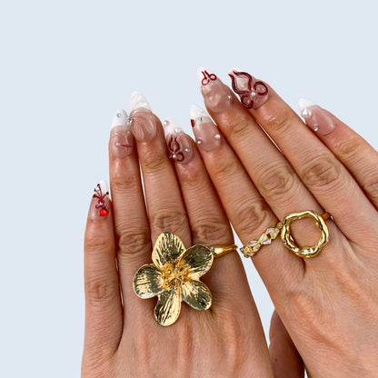 Angled view of Ribbon Bliss almond nails displaying 3D pearl hearts and bows