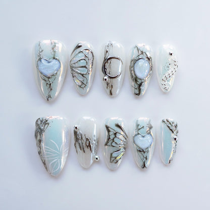 Full 10-piece flat lay display of Gossamer Butterfly liquid silver press-on nails