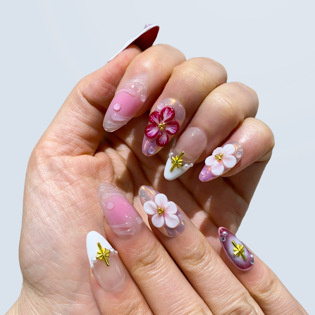 Full hand display of Celestial Blossom Fairy pink ombre nails with pearl charms