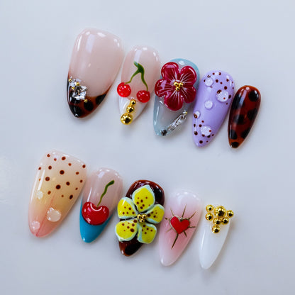 Handcrafted floral pink gel fake nails in natural light for spring picnics and daytime outings