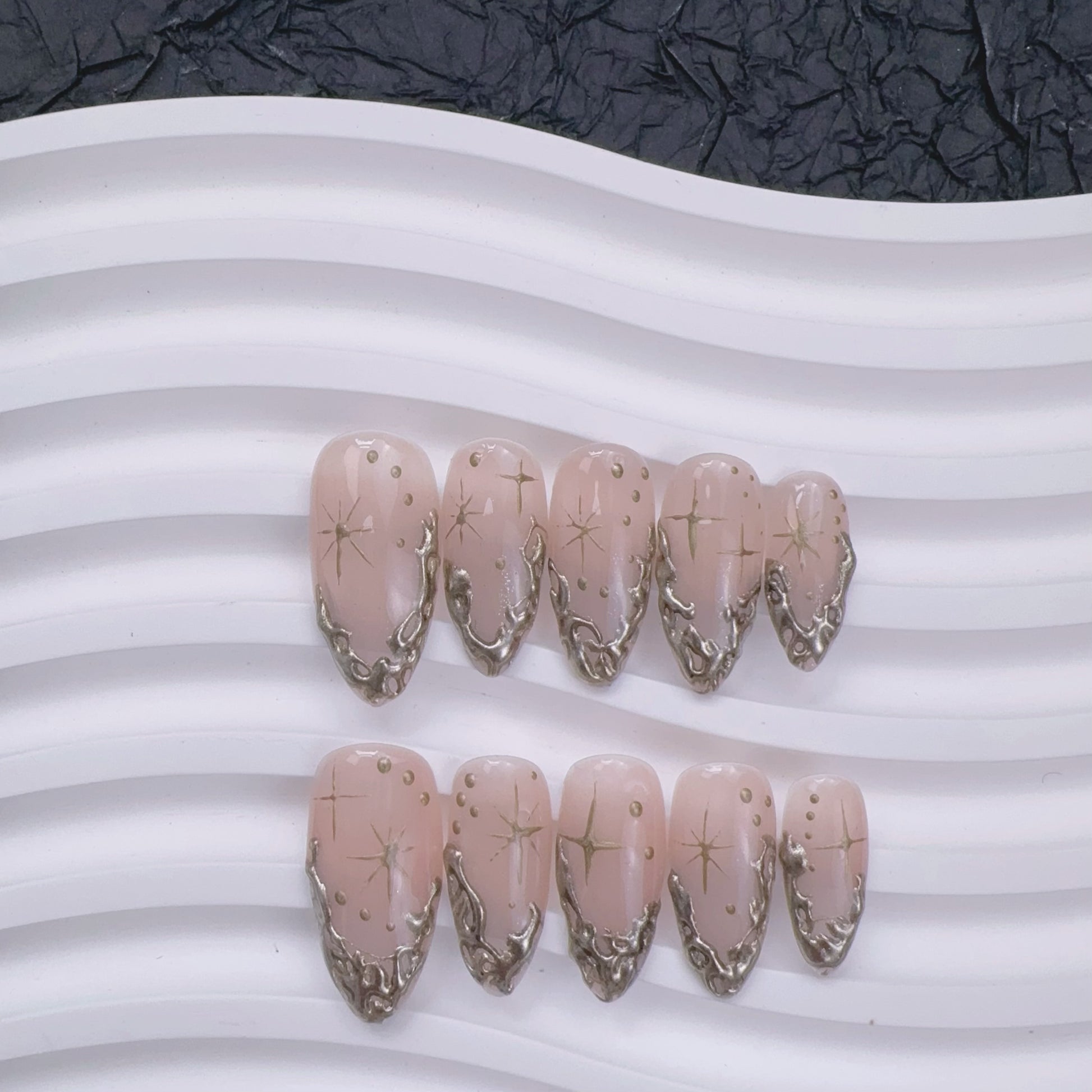 Luxury gold gel manicure with handcrafted art detailing close-up