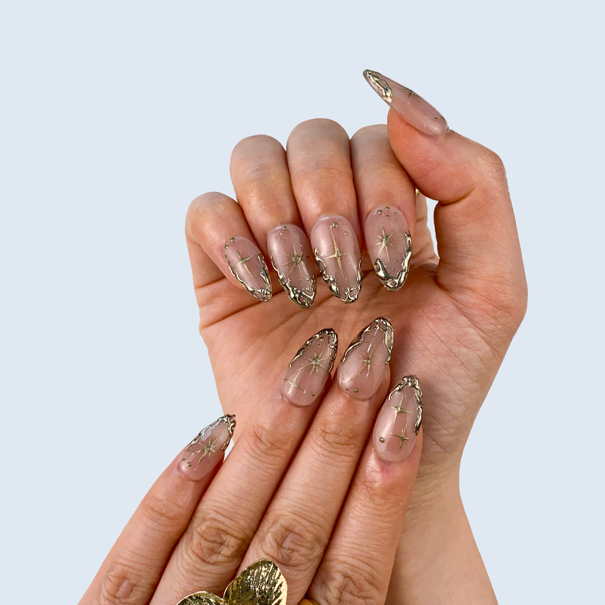 Full set wear display of Gilded Serenity sheer nude and gold star press-on nails