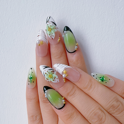Angled view of Mint Floral Whisper nails displaying deep emerald French tips and pearls