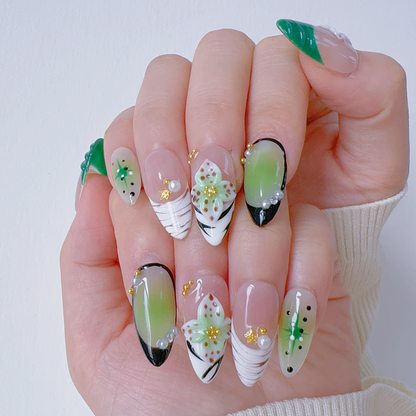On-hand try-on of Mint Floral Whisper nails showing matcha green aura and 3D petals