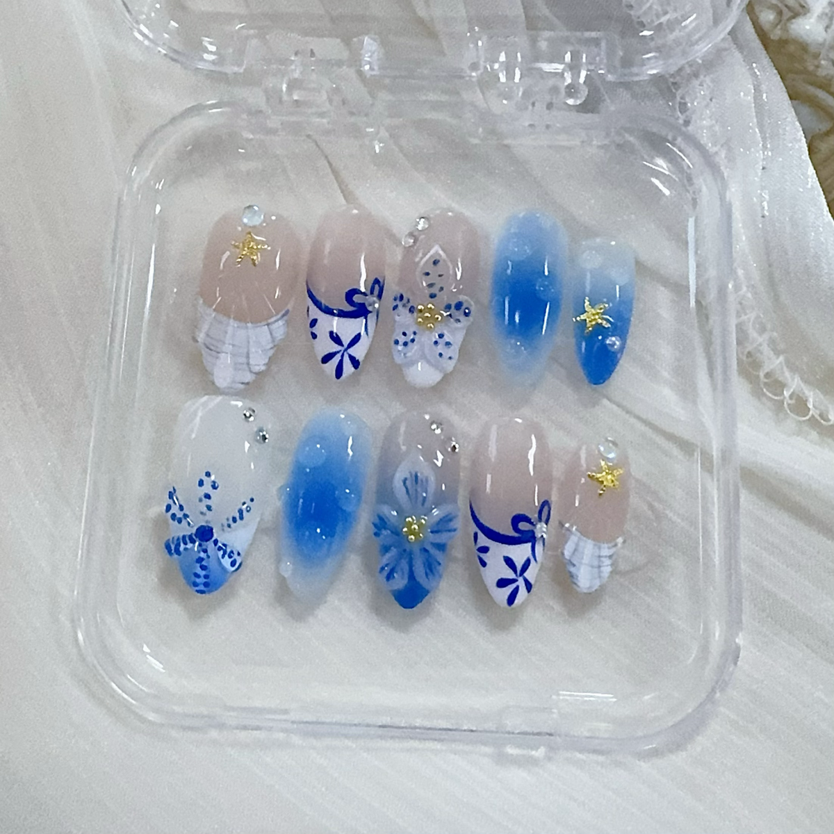 Mermaidcore blue almond press-on nails flat lay | Mermaidcore manicure inspo