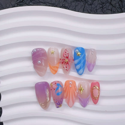 Flat lay view of Mermaid's Serenade nails on ceramic wave tray showing 3D shell art