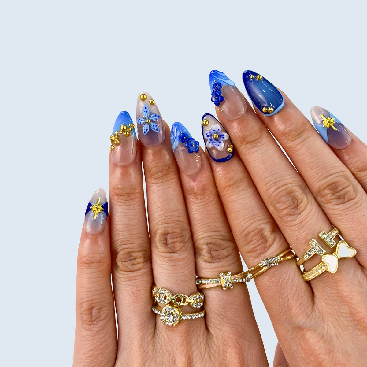 Full set wear display of Moonlit Petals royal blue aura almond press-on nails
