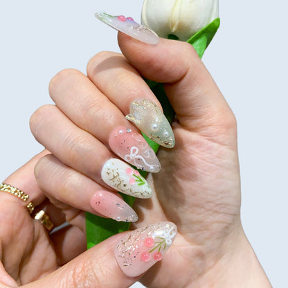 On-hand try-on of Fairy Secrets nails showing 3D sculpted tulips and gold vines