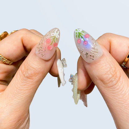 Thumbs closeup of Fairy Secrets nails showing 3D pink tulip bouquet and blue aura