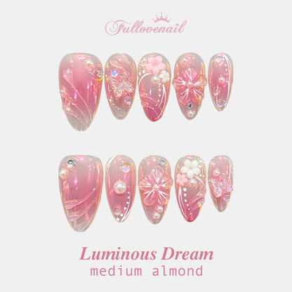 Luminous Dream almond press-on nails with glazed pink chrome and 3D floral charms