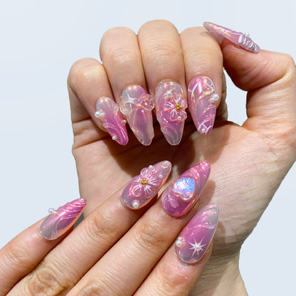 Full hand display of Fairy Glaze nails displaying pink aura gel and pearls