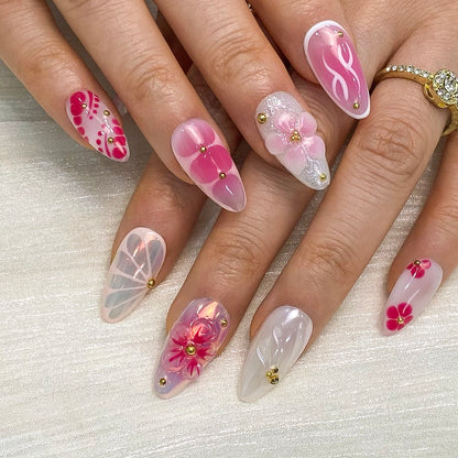On-hand try-on of Petal Pop almond nails showing 3D blossoms and glossy pink swirl details