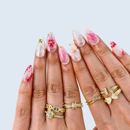 Ten finger full set display of Petal Pop nails showing French swirls and 3D flower art