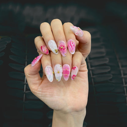 Petal Pop almond press-on nails worn on hand in natural lighting with 3D floral art