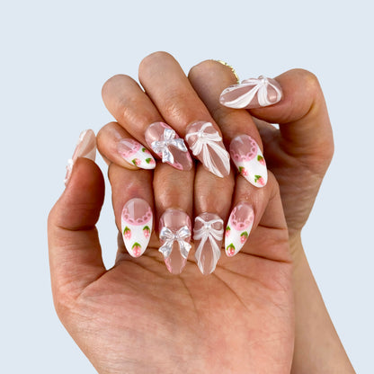 Blush Ballet nail art close-up showing handcrafted art detailing on almond nails