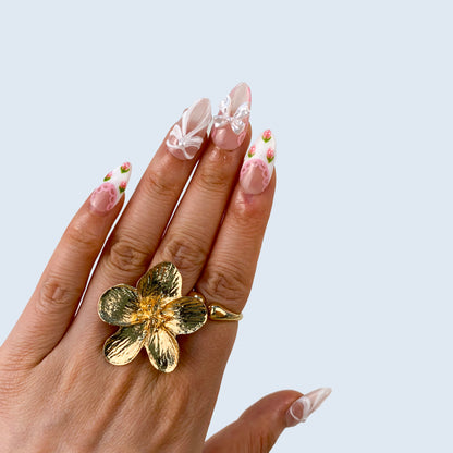 Luxury pink gel manicure with handcrafted art detailing on hands close up