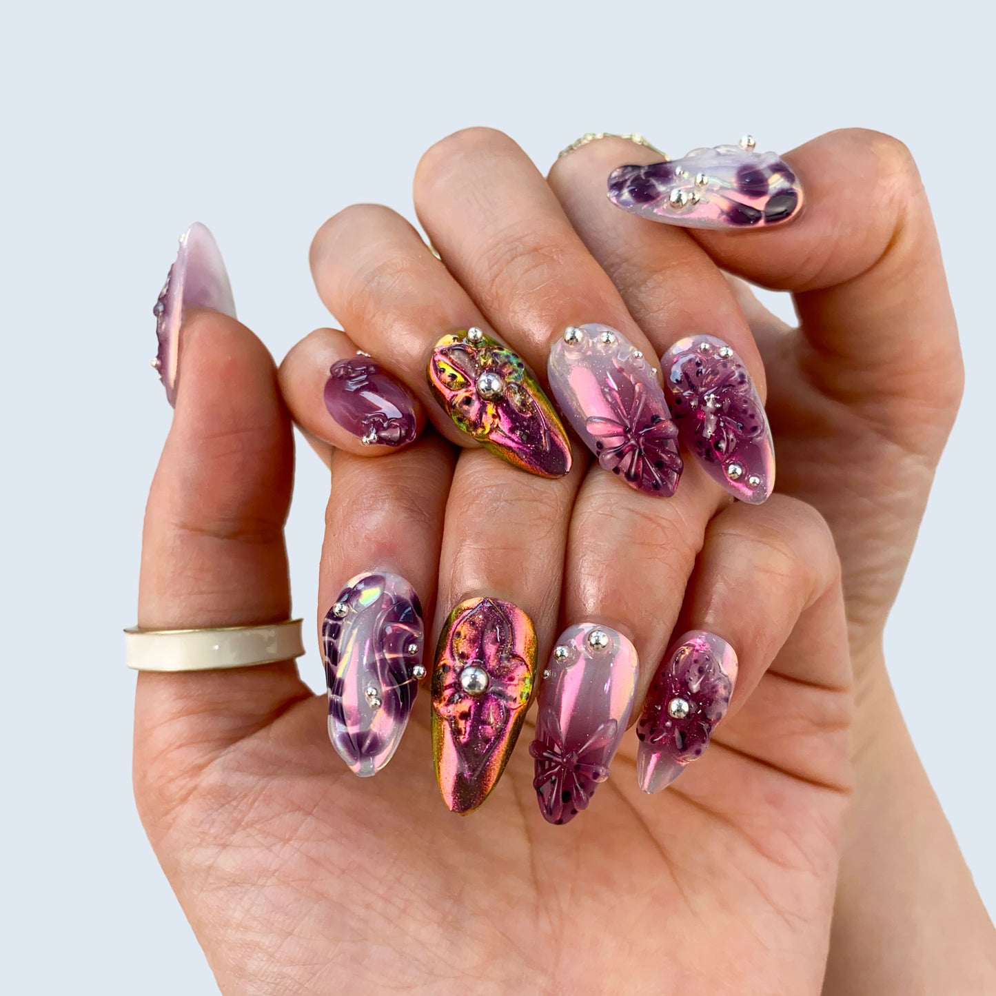 Violet Gleam nail art close-up showing deep galaxy cat eye shimmer and glossy gel finish